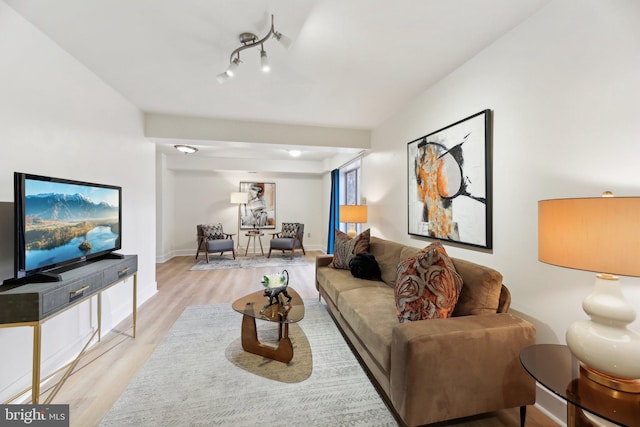 living area featuring baseboards and wood finished floors