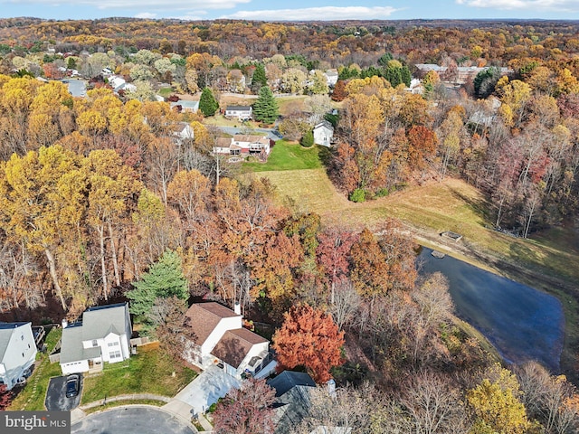 bird's eye view featuring a forest view and a water view