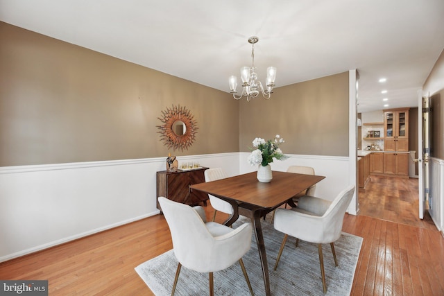 dining room featuring a chandelier, recessed lighting, baseboards, and light wood-style floors