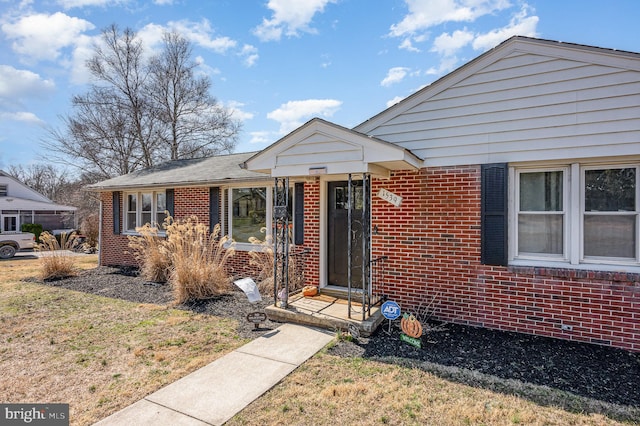 bungalow-style house featuring brick siding