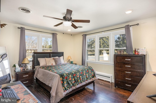 bedroom with visible vents, a baseboard heating unit, recessed lighting, ceiling fan, and dark wood-style flooring