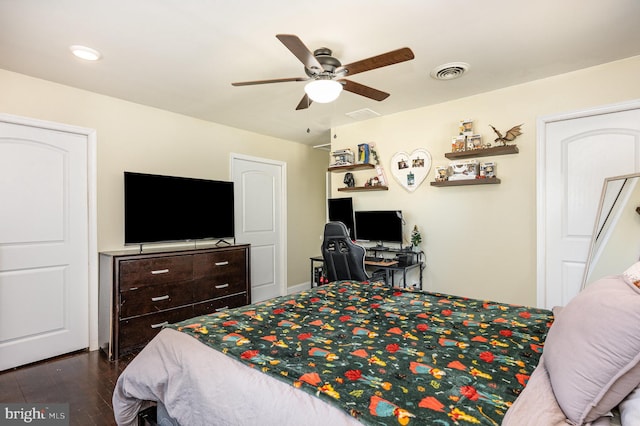 bedroom featuring visible vents, dark wood finished floors, and a ceiling fan