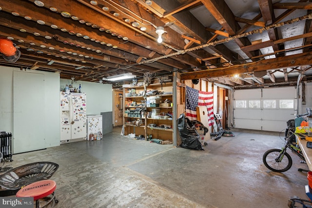 garage featuring white fridge with ice dispenser