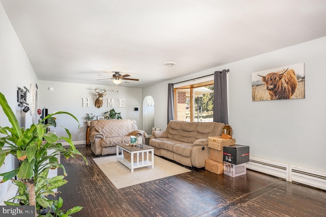 living room with baseboards, baseboard heating, wood finished floors, and a ceiling fan