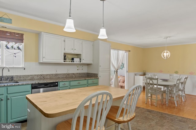 kitchen with butcher block countertops, dishwasher, and crown molding