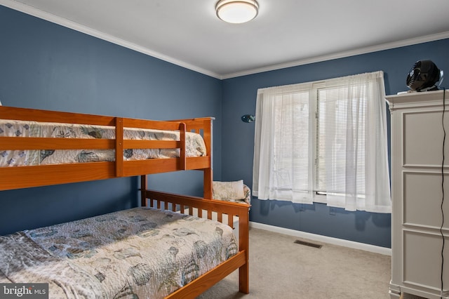 bedroom with visible vents, baseboards, crown molding, and carpet