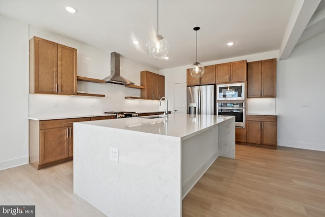 kitchen featuring stainless steel appliances, open shelves, a sink, light wood-type flooring, and wall chimney exhaust hood