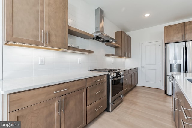 kitchen featuring open shelves, decorative backsplash, appliances with stainless steel finishes, light wood-type flooring, and wall chimney exhaust hood