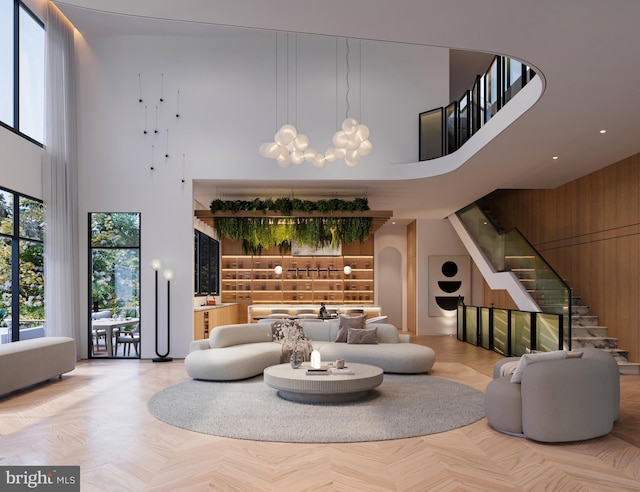 interior space featuring a towering ceiling, stairway, arched walkways, and a chandelier