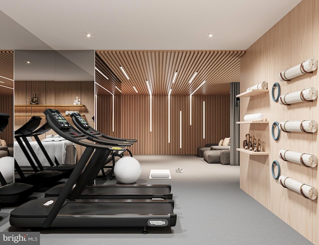 exercise room featuring wood walls