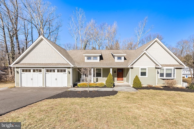 view of front of property with aphalt driveway, a porch, an attached garage, a shingled roof, and a front lawn