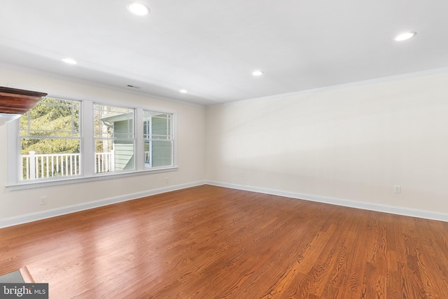 unfurnished room with recessed lighting, baseboards, crown molding, and wood finished floors