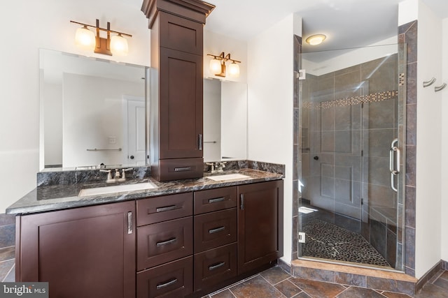 bathroom with double vanity, a stall shower, and a sink