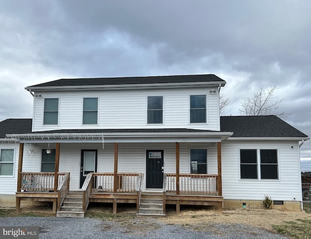 view of front of property featuring covered porch, crawl space, and roof with shingles