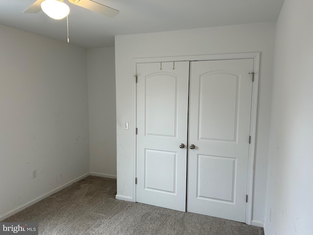 unfurnished bedroom featuring a ceiling fan, a closet, carpet flooring, and baseboards