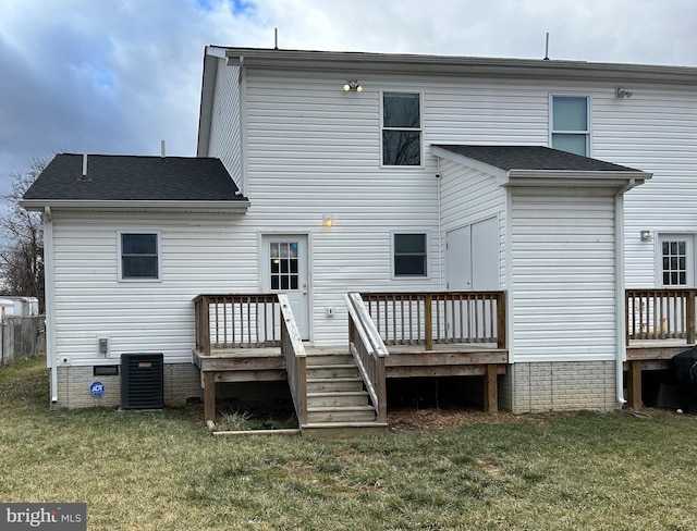 back of property with a lawn, cooling unit, and a wooden deck