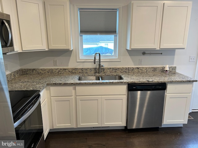 kitchen with stainless steel appliances, white cabinets, and a sink