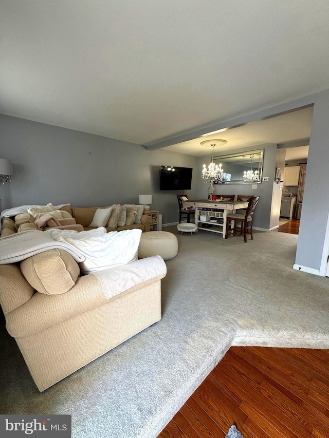 living area with an inviting chandelier, wood finished floors, and baseboards