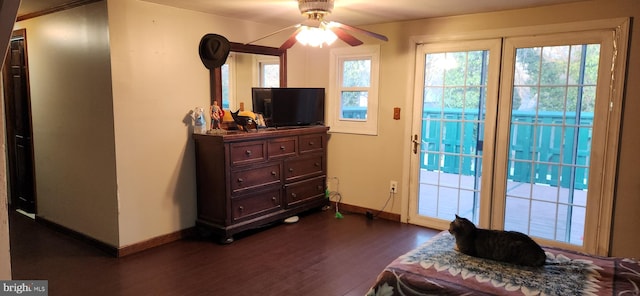 interior space featuring access to exterior, a ceiling fan, baseboards, and dark wood-style flooring