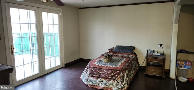 bedroom featuring access to exterior, multiple windows, baseboards, and dark wood-type flooring