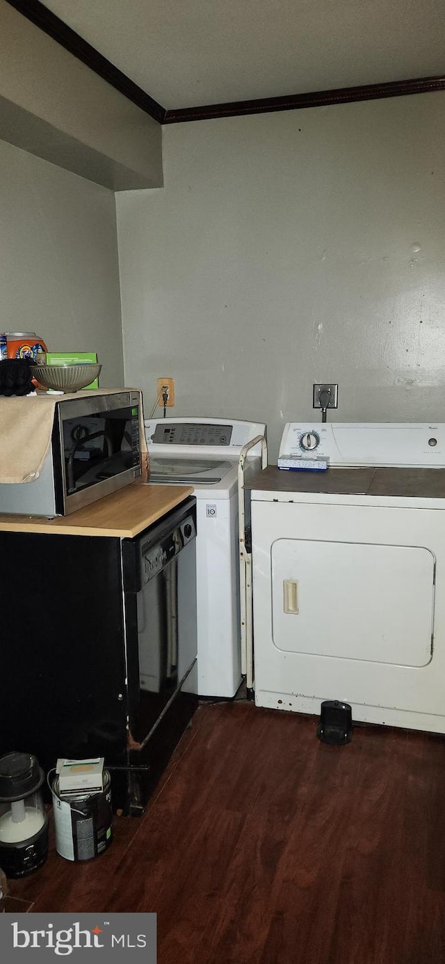 laundry area with ornamental molding, laundry area, separate washer and dryer, and dark wood finished floors