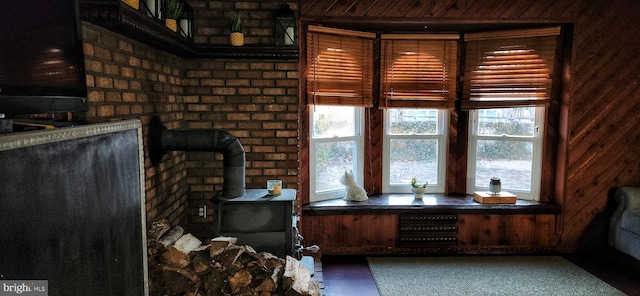 office area featuring a wood stove and wood walls