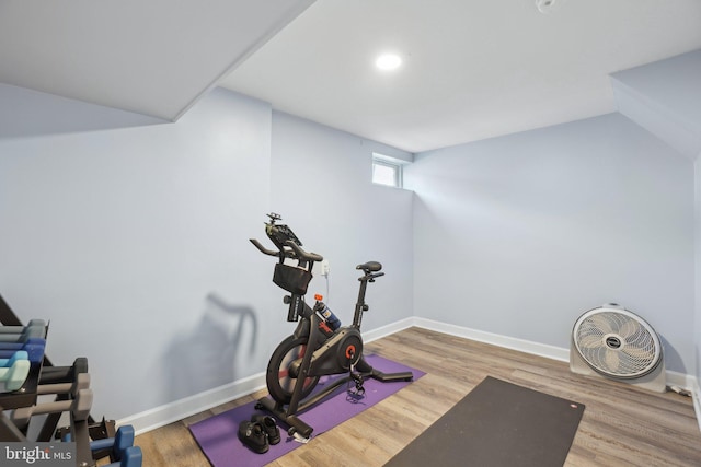 workout area with baseboards and wood finished floors