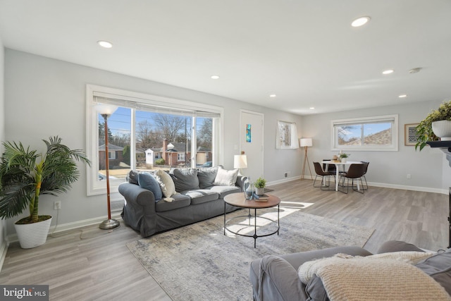 living room featuring recessed lighting, baseboards, and wood finished floors