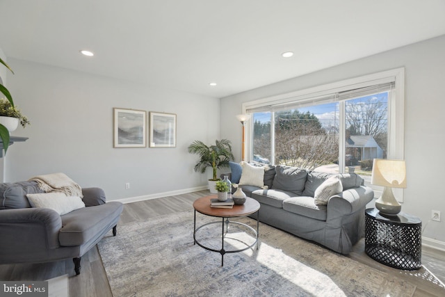 living room with recessed lighting, baseboards, and wood finished floors