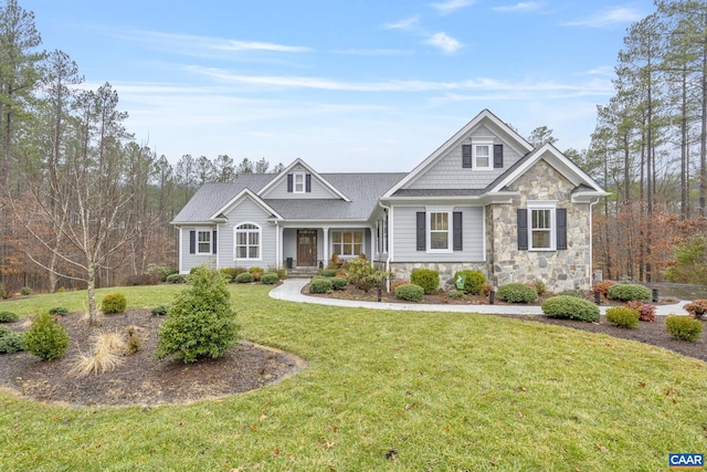 craftsman inspired home featuring stone siding and a front yard