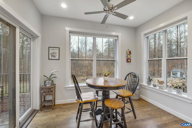 dining space with a ceiling fan, recessed lighting, wood finished floors, and baseboards