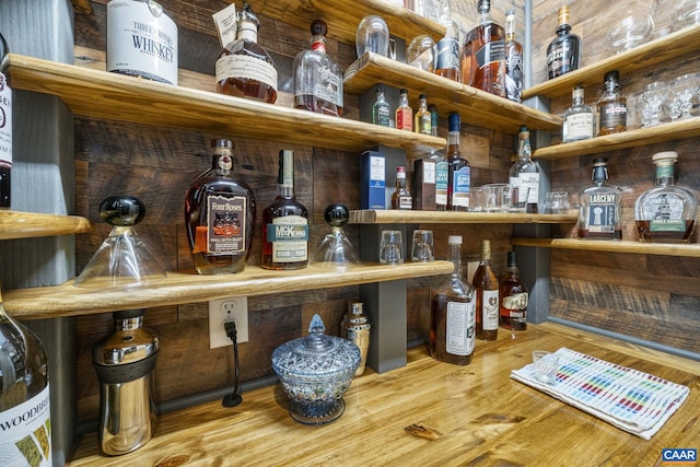 bar featuring a bar and wood finished floors