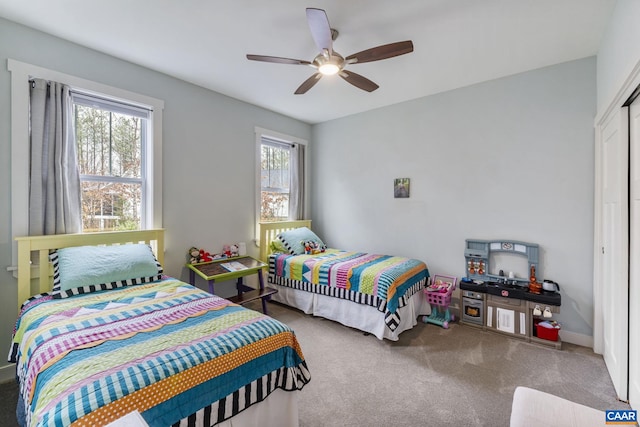 bedroom with a closet, ceiling fan, and carpet floors