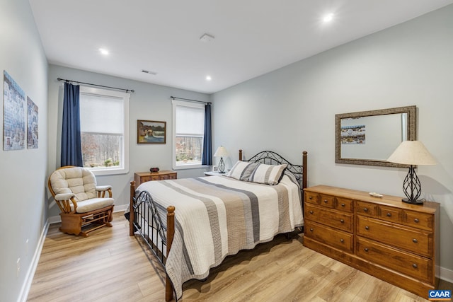 bedroom with visible vents, recessed lighting, light wood-type flooring, and baseboards