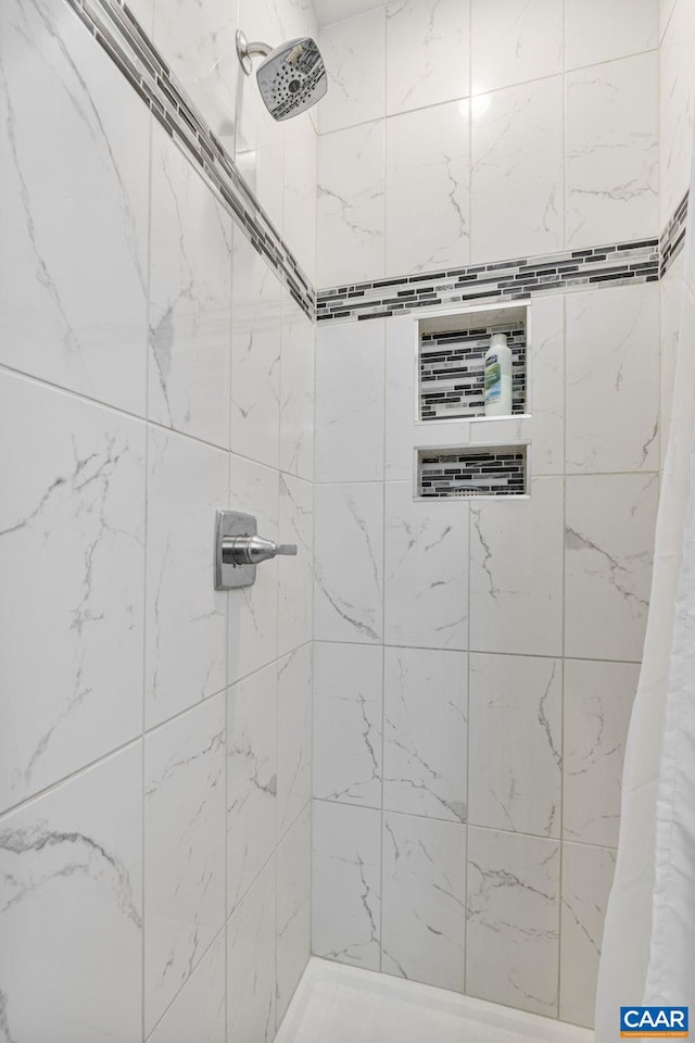 full bathroom with a tile shower