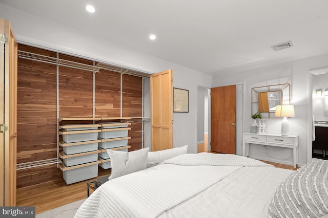 bedroom featuring wood finished floors, visible vents, and recessed lighting