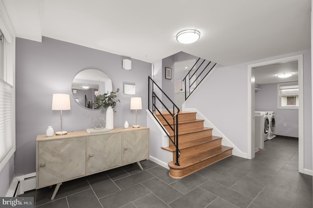 stairs featuring baseboards, washing machine and dryer, a baseboard heating unit, and tile patterned flooring