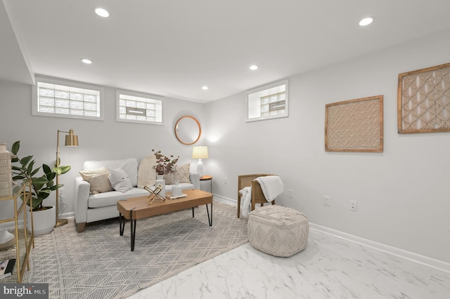 living area featuring recessed lighting, marble finish floor, and baseboards