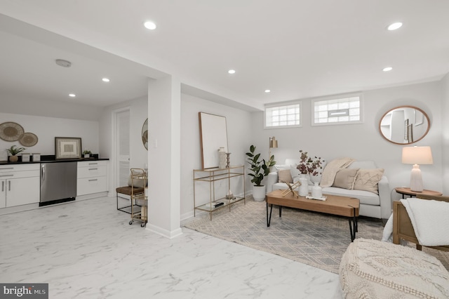 living area featuring baseboards, marble finish floor, and recessed lighting