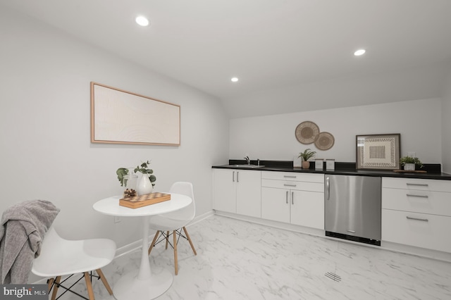 kitchen with recessed lighting, refrigerator, a sink, white cabinets, and marble finish floor