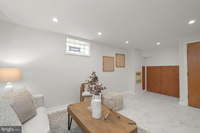 living room with baseboards, marble finish floor, and recessed lighting