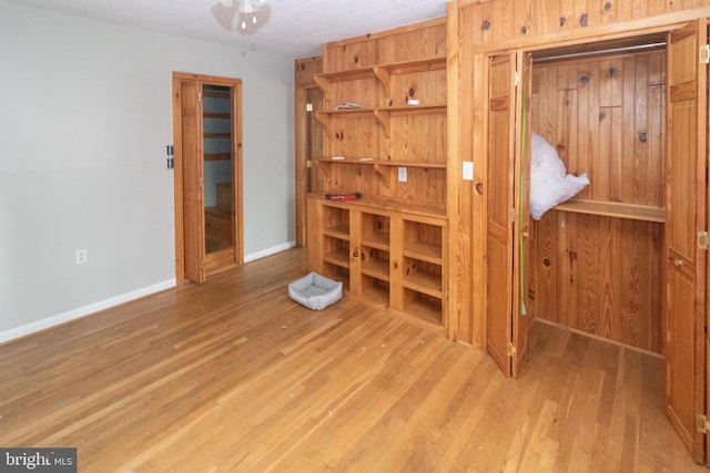 bedroom featuring wood finished floors and baseboards