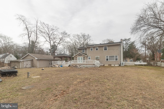 back of property with a yard, a chimney, and a wooden deck