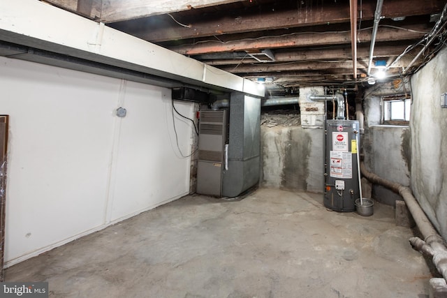 basement featuring water heater and heating unit