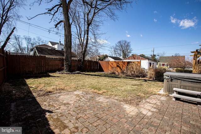 view of yard with a patio, a fenced backyard, and a hot tub