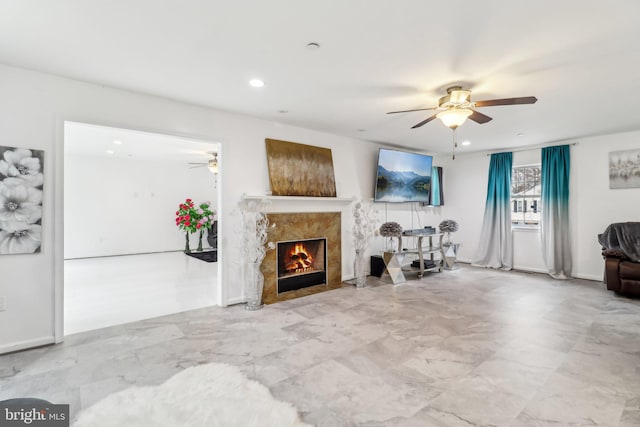 living room with recessed lighting, ceiling fan, and a high end fireplace