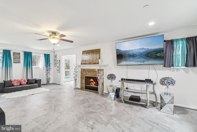 living area with recessed lighting, a premium fireplace, a ceiling fan, baseboards, and marble finish floor