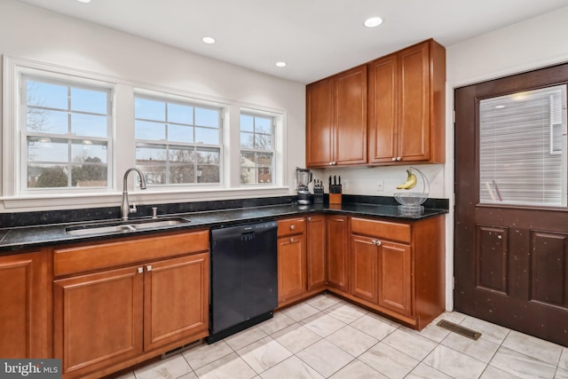 kitchen with dishwasher, a sink, and brown cabinets