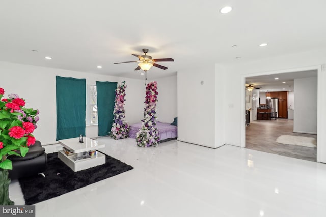 unfurnished living room featuring concrete flooring, a ceiling fan, and recessed lighting