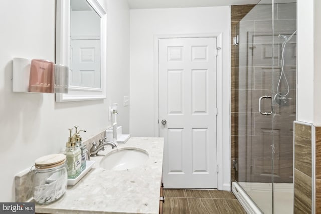 full bathroom with a shower stall and vanity